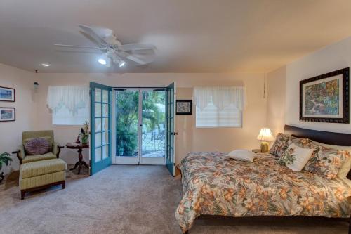 a bedroom with a bed and a ceiling fan at Hale O Makani home in Keaau