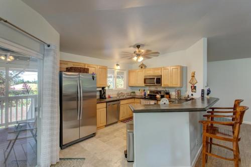 a kitchen with a stainless steel refrigerator and wooden cabinets at Ferns & Frogs Forest Hale home in Mountain View