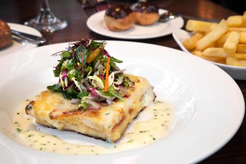 a white plate with a piece of food with a salad on it at Holiday Inn - Glasgow - City Ctr Theatreland by IHG in Glasgow