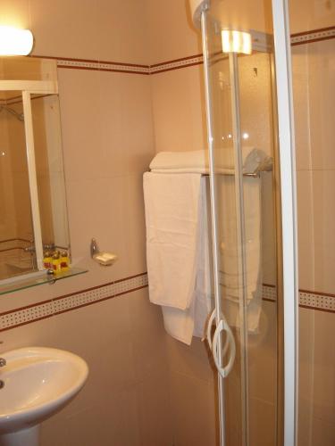 a bathroom with a shower and a sink at Hotel Brilliantin in Sliven