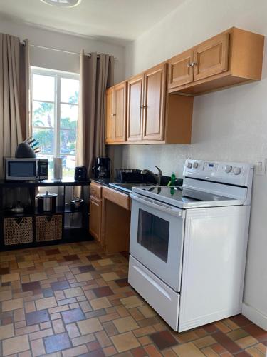 a kitchen with a white stove top oven next to a window at Harding Boutique Apartments in Miami Beach