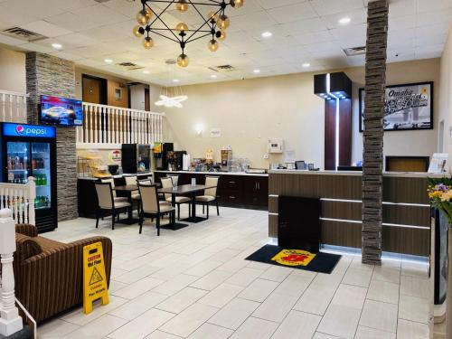 a restaurant with tables and chairs and a counter at Super 8 by Wyndham Omaha SW in Omaha