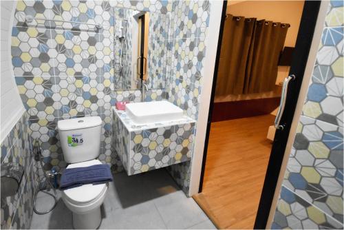 a bathroom with a toilet and a sink at Tiny hut resort in Bangkok