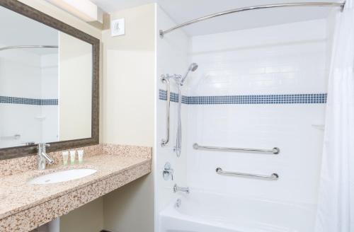 a bathroom with a shower and a sink at Staybridge Suites Seattle - Fremont by IHG in Seattle