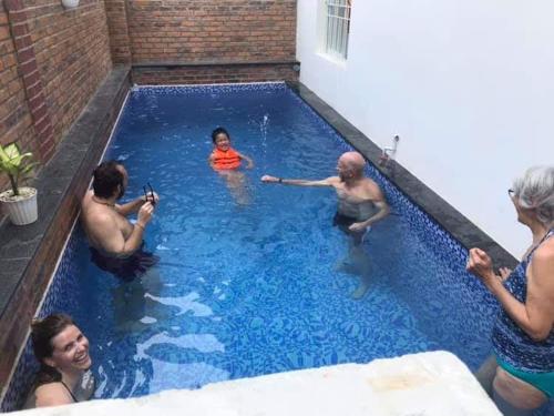 a group of people in a swimming pool at Hue Four Seasons Hotel in Hue