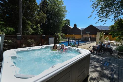 a little girl swimming in a hot tub at Manata Homestead & Lodge in Queenstown