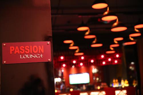 a red sign that reads passion lounge with red lights at Park Plaza, Ludhiana in Ludhiana