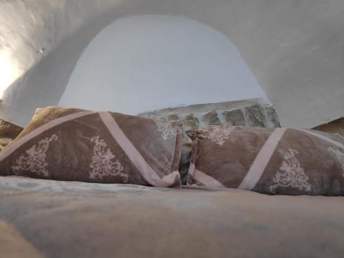 a pillow sitting on a bed in a room at Dar Jacaman - In the heart of Bethlehem old city in Bethlehem