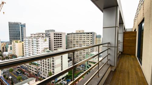 a balcony with a view of a city at Hotel Haema in Jeju