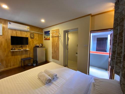 a bedroom with a bed with towels on it at Bed in Beyt Boutique Hotel in Nonthaburi