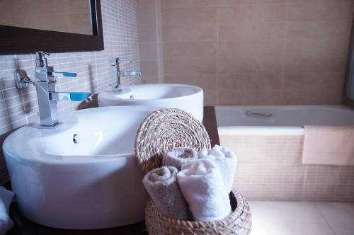 a bathroom with a sink and a toilet and a tub at Double View Apartment in Agia Marina Nea Kydonias
