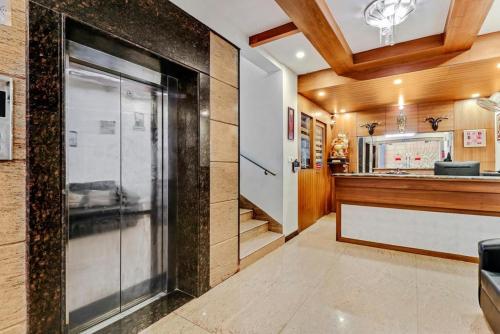 a restaurant with a glass door in a room at Sri Krishna Palace in Hosūr