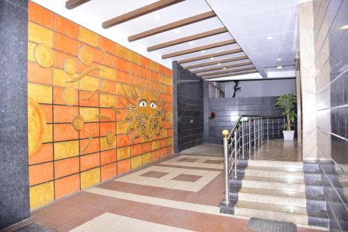 a hallway with a wall with a painting of a butterfly at Sri Krishna Palace in Hosūr