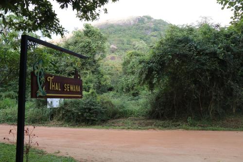 a sign for a hill station on a dirt road at Thal Sewana in Sigiriya