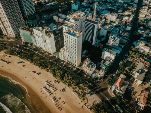 an aerial view of a city with a beach and buildings at Navada Beach Hotel in Nha Trang