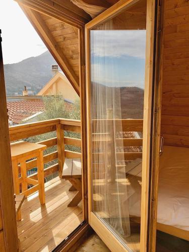 a glass door to a balcony with a view at Apartments "Old house Pajovic" in Virpazar