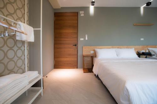 a bedroom with two beds and a door at Chance Villa 262 in Jiaoxi