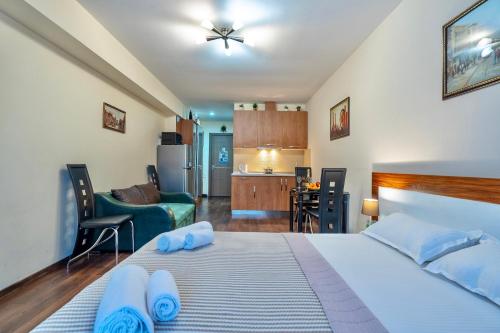 a bedroom with a bed with blue towels on it at GVC New Gudauri in Gudauri