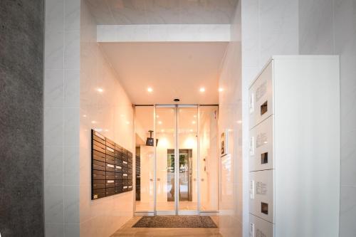 a hallway with a glass door in a building at momo premium 202 in Sapporo