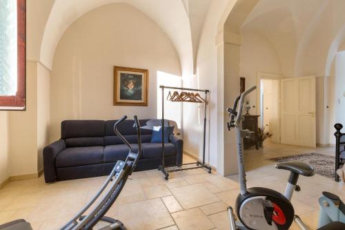 a living room with a couch and a exercise bike at Dimora Maria Luisa by BarbarHouse in Merine