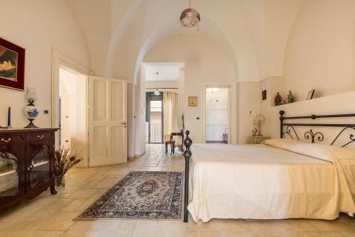 a large bedroom with a bed and a rug at Dimora Maria Luisa by BarbarHouse in Merine