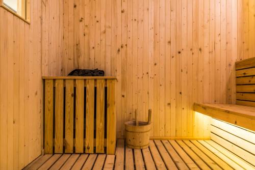 a corner of a wooden sauna with a trash can at Swissôtel Jakarta PIK Avenue in Jakarta