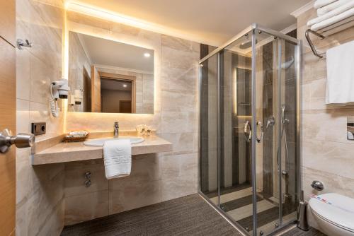 a bathroom with a sink and a shower at My Home Resort Hotel- Ultra All Inclusive in Avsallar