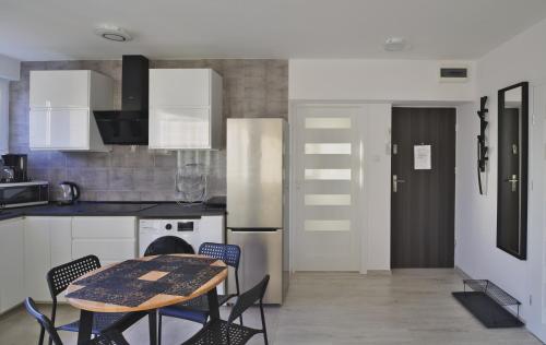 a kitchen with a table and chairs in it at Amik apartament-Night View in Wrocław