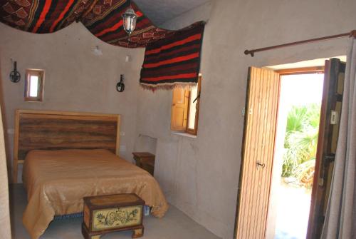 Postel nebo postele na pokoji v ubytování Grand Sud, la maison de sable