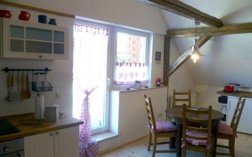 eine Küche mit einem Tisch und einem großen Fenster in der Unterkunft Auszeit-Landleben Domizil in Sallgast
