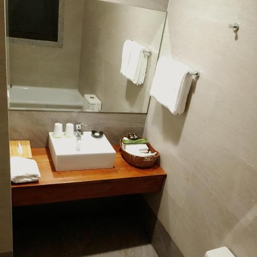 a bathroom with a white sink and a mirror at Lin's Inn in Ruisui