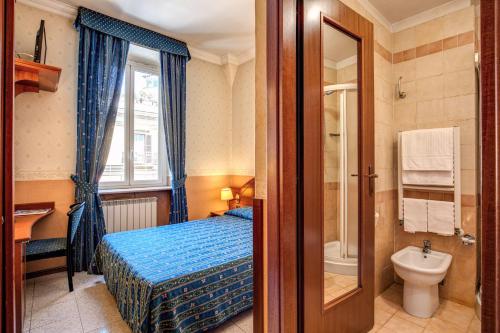 a bedroom with a bed and a bathroom with a toilet at Hotel Verona Rome in Rome