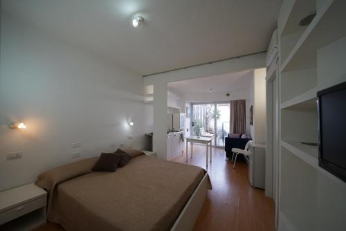 a bedroom with a bed and a living room at Holiday home Isola Rossa in Isola Rossa