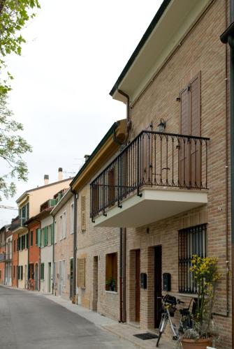a balcony on the side of a brick building at Lo Squero Rooms and Apartments in Fano