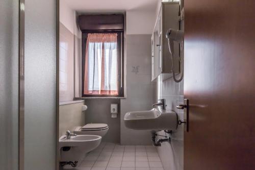 a bathroom with a toilet and a sink at Hotel Maris in Sala Baganza