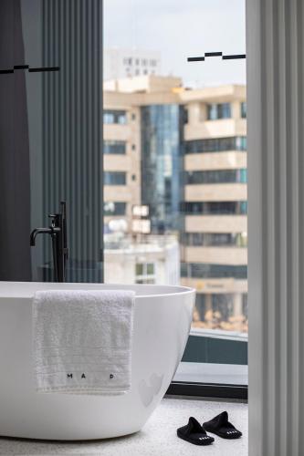 a bathroom with a white sink and a window at MAP Boutique Hotel in Nicosia