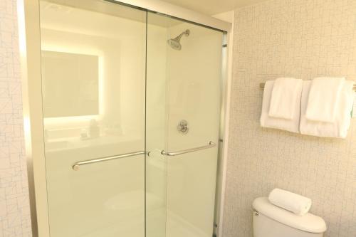 a bathroom with a shower and a toilet at Holiday Inn Express Phoenix-Airport/University Drive by IHG in Phoenix