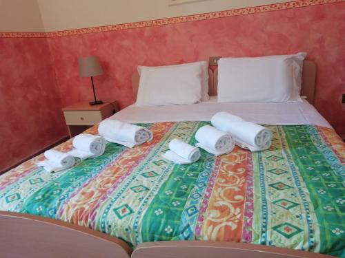 a bed with four rolls of toilet paper on it at Hostel il Tetto in Melfi