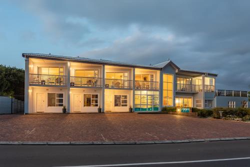 a large apartment building with a lot of windows at Aire del Mar Guest House in Gansbaai