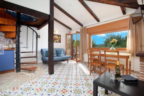 a living room with a table and a dining room at Relais Il Frantoio in Massa Lubrense