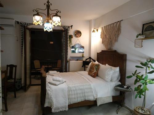 a bedroom with a bed and a chandelier at Studio 21 in Heraklio