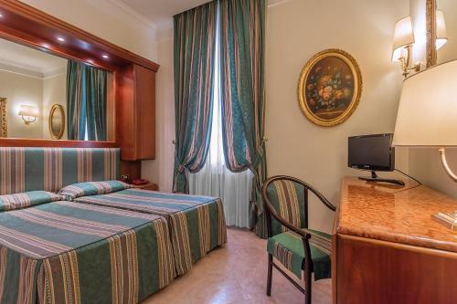 a hotel room with a bed and a window at Raeli Hotel Lazio in Rome