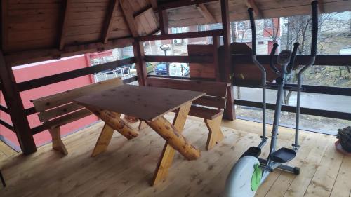 a wooden table and a bench in a room at Apartments Life in Kolašin