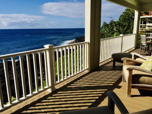 a porch with a view of the ocean at THE JEWEL BOX home in Pahoa