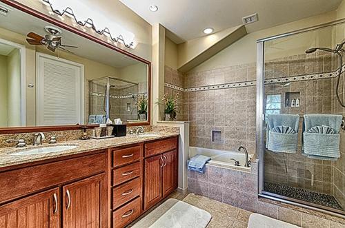 a bathroom with a shower and a sink and a tub at Waikoloa Beach Villas O-33 condo in Waikoloa
