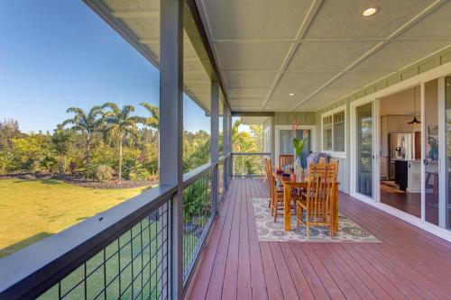 a porch with a table and chairs on it at Pua Lani in Keaau