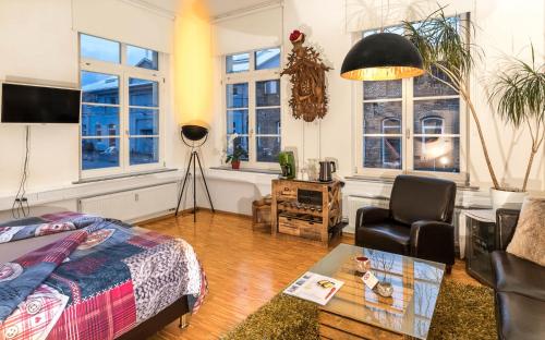 ロットヴァイルにあるSchwarzwaldzimmer & Schwarzwald Design Apartmentのリビングルーム(ベッド1台、テーブル付)