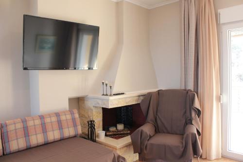 a living room with a chair and a fireplace at Apartment Achilles in Litochoro