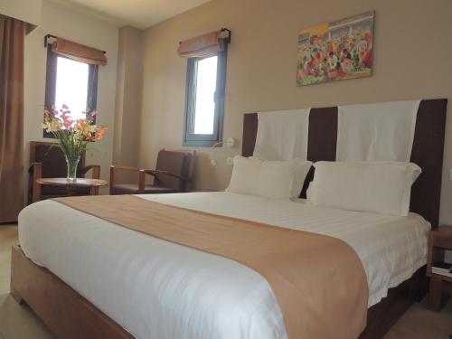 Postel nebo postele na pokoji v ubytování Plumeria Hotel