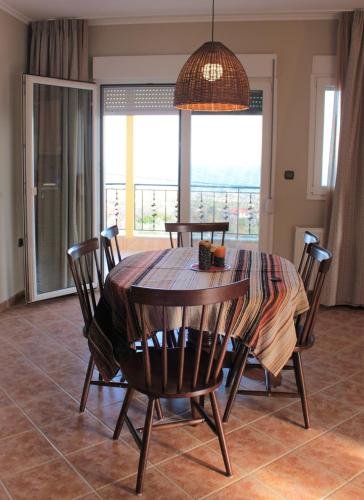 a dining room with a table and chairs and a window at Apartment Achilles in Litochoro